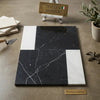 Black and white Italian marble tile Bari in Nero Marquina 12x12 and Carrara White 4x12 set with geometric veining pattern