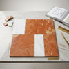 A polished orange and white marble tile panel bari in rojo alicante and carrara white with geometric natural veining pattern