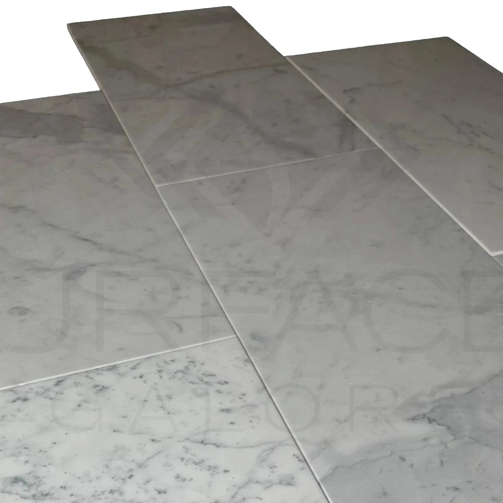 Marble-patterned Bianco Carrara Standard 12X24 Polished Marble Tile in a stylish display