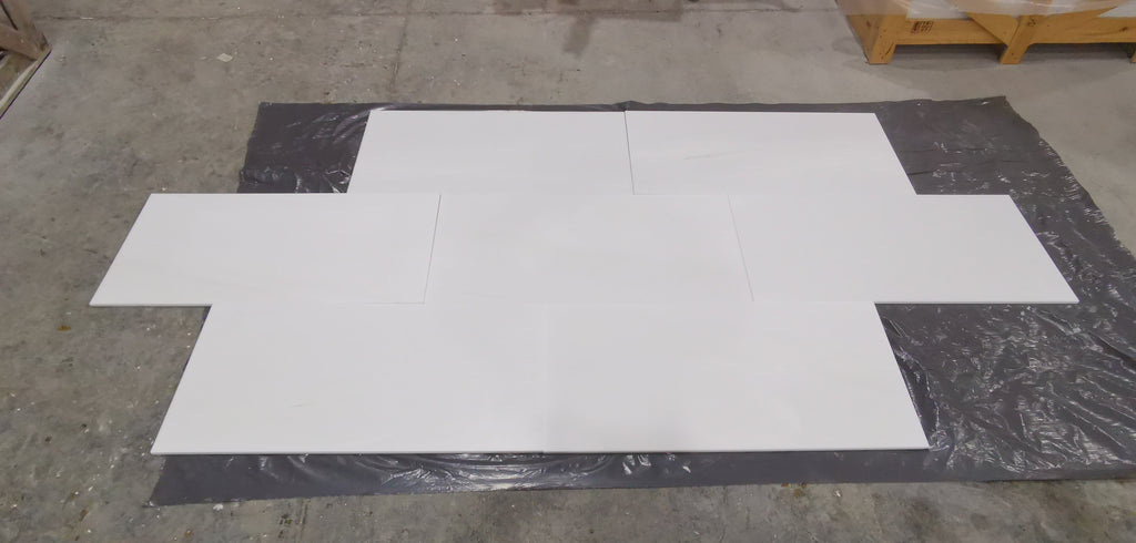 White Bianco Dolomite marble tiles in cross pattern on black sheet