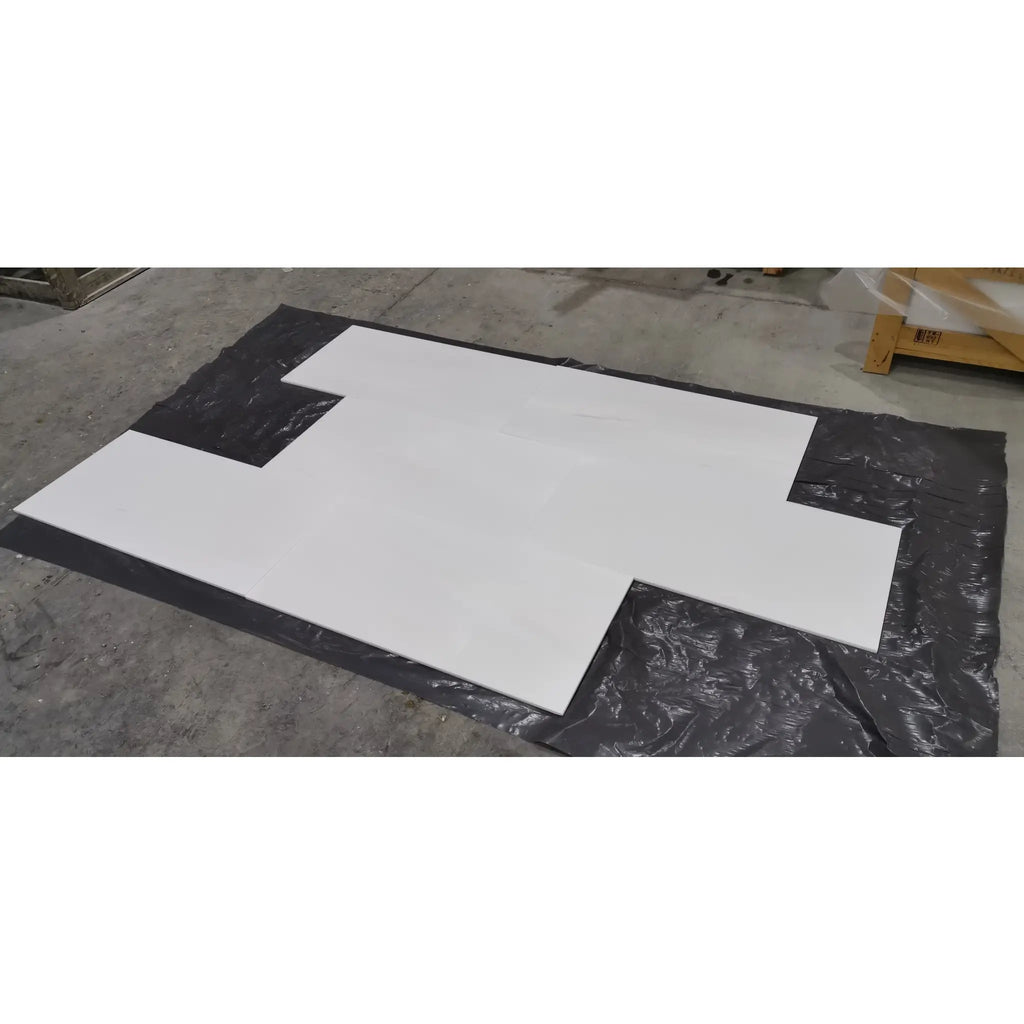 White Bianco Dolomite 18x36 honed marble panels on black sheeting