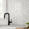 Black matte finish kitchen faucet with modern gooseneck spout and single lever handle paired with bianco dolomite marble mosaic
