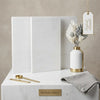 White ceramic vase with gold metallic accents and rim placed on bianco dolomite 24x24 marble polished surface