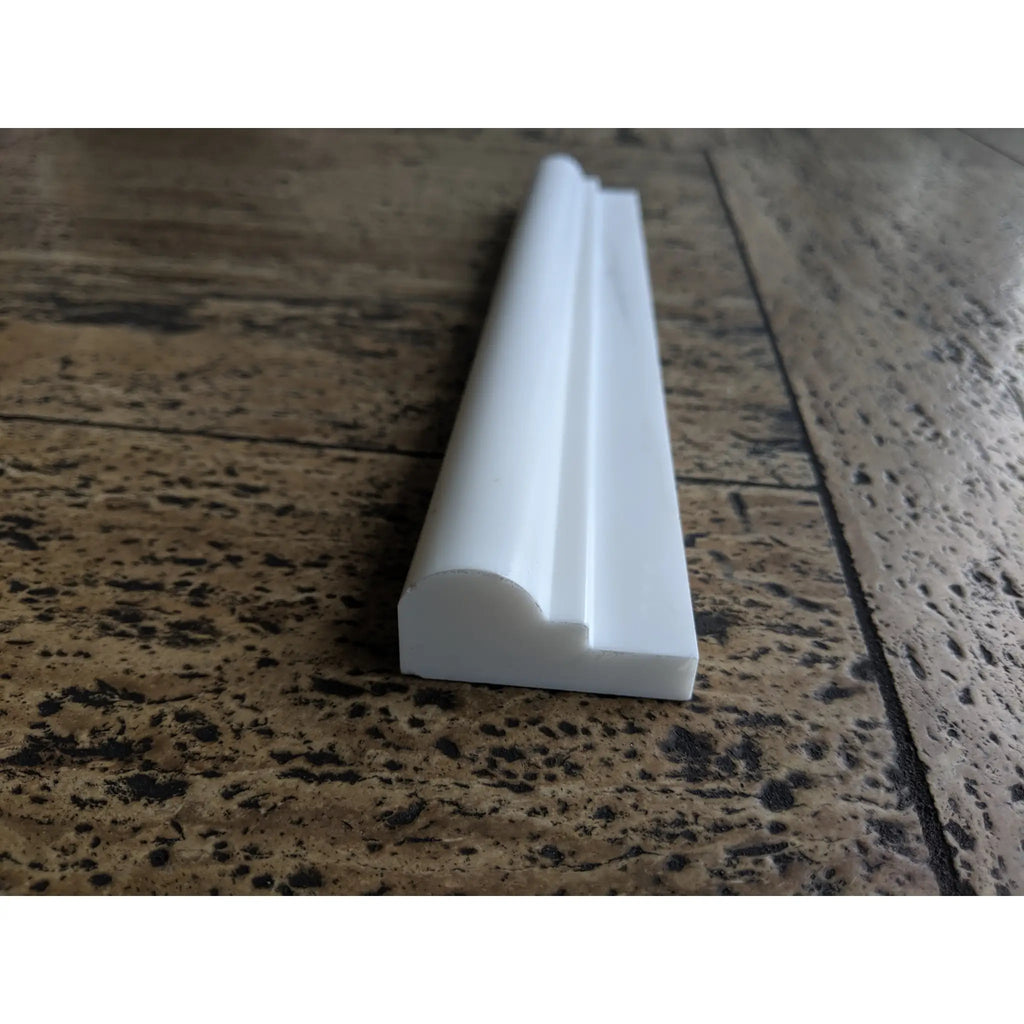 White plastic door threshold strip with Bianco Dolomite marble profile