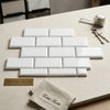 White rectangular bianco dolomite marble subway tiles arranged in a deep-beveled 2x4 brick pattern polished-honed