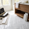 White dolomite 2x8 marble polished tiles in bianco arranged in a herringbone pattern on floor