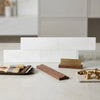 White dolomite 4x12 marble polished and honed tile samples displayed in a stepped arrangement showing surface finishes