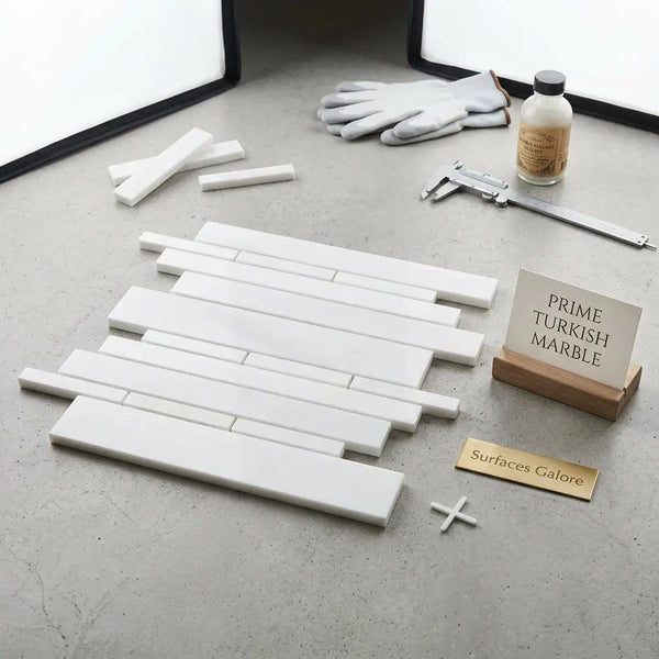 White rectangular bianco dolomite turkish marble tiles arranged in a staggered random-strip polished mosaic pattern