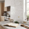 Open cookbook with scandinavian kitchen title on marble countertop featuring Bianco Dolomite white dolomite mosaic marble tumbled