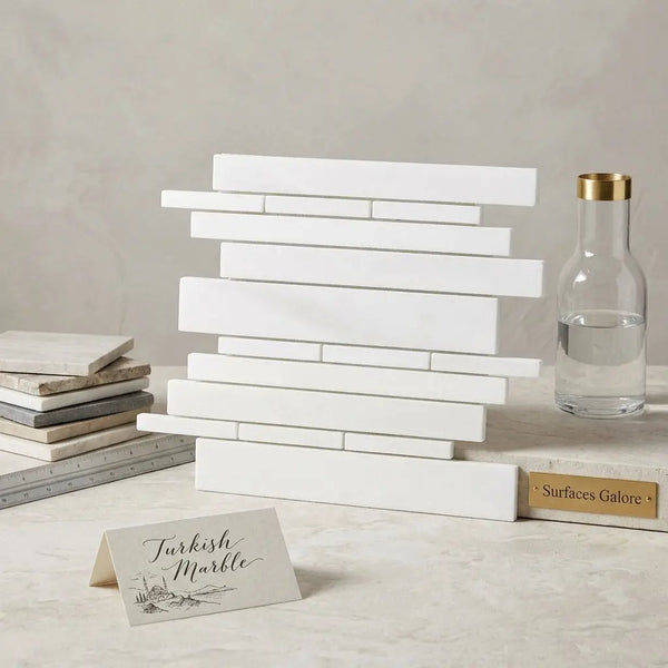 Stack of bianco dolomite white dolomite rectangular marble tiles arranged in a staggered random-strip mosaic pattern