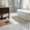 White freestanding octagon bathtub with gold fixtures made of bianco dolomite and blue gray mosaic marble finish