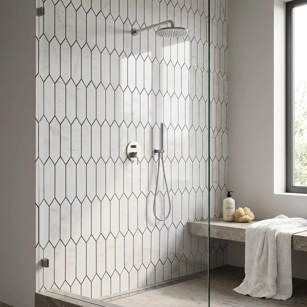 Modern chrome showerhead with a sleek circular design mounted on a bianco dolomite white dolomite picket mosaic marble wall fixture