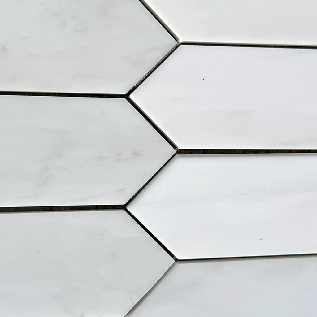 White elongated hexagon tiles in Bianco Dolomite Marble 3’’ X 12’’ Picket Mosaic