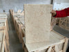 Bordeaux Rustique 16X24 beige speckled granite slab upright in warehouse