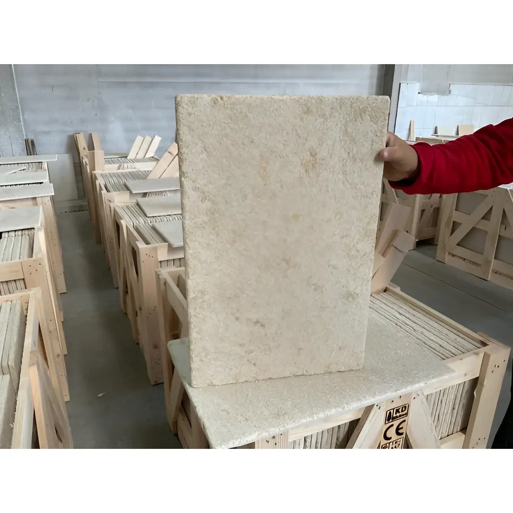 Bordeaux Rustique 16X24 beige speckled granite slab upright in warehouse