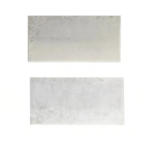 Two rectangular metal plates beside Botticino Cream White Marble tile for sale