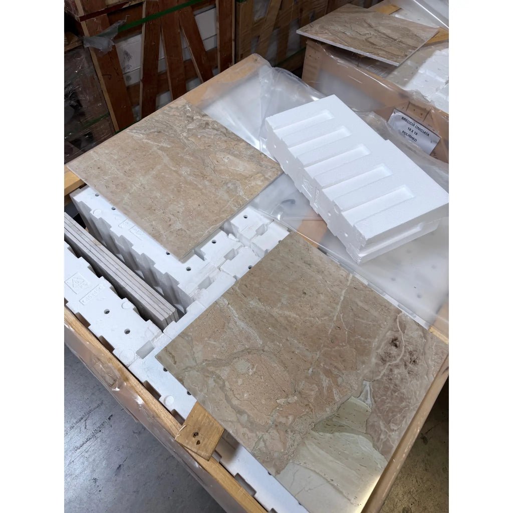 Beige breccia oniciata italian marble tiles with natural veining and polished finish in protective foam packaging