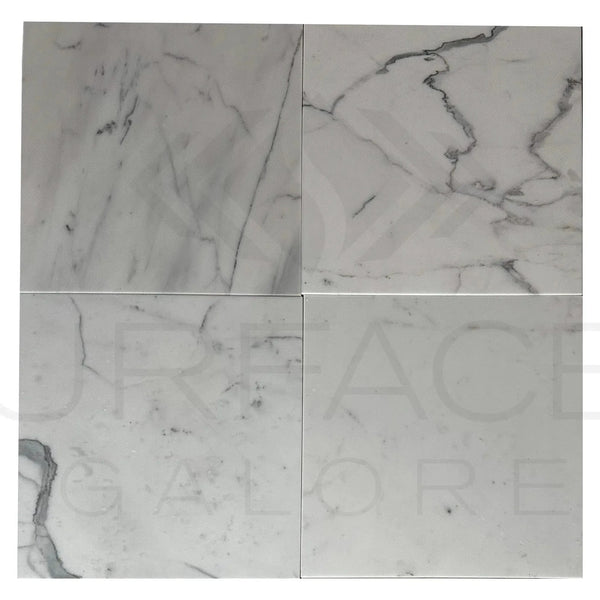 Four white Calacatta Carrara polished marble tiles showcasing elegant design