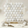 White hexagonal calacatta gold marble mosaic tile panel with subtle veining and polished modern design