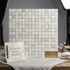 A square panel of calacatta gold 1x1 mosaic marble tile in light color with subtle veining and polished finish