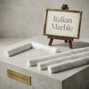 Calacatta Gold 1x12 quarter-round trim molding in polished white Italian marble with subtle gray veining on concrete pedestal