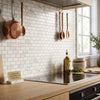 Calacatta gold 1x2 brick mosaic marble tile polished or honed with white subway tile backsplash and subtle gray veining