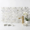 White marble tile backsplash with subtle gray veining in an offset brick layout calacatta gold 1x2 mosaic tile
