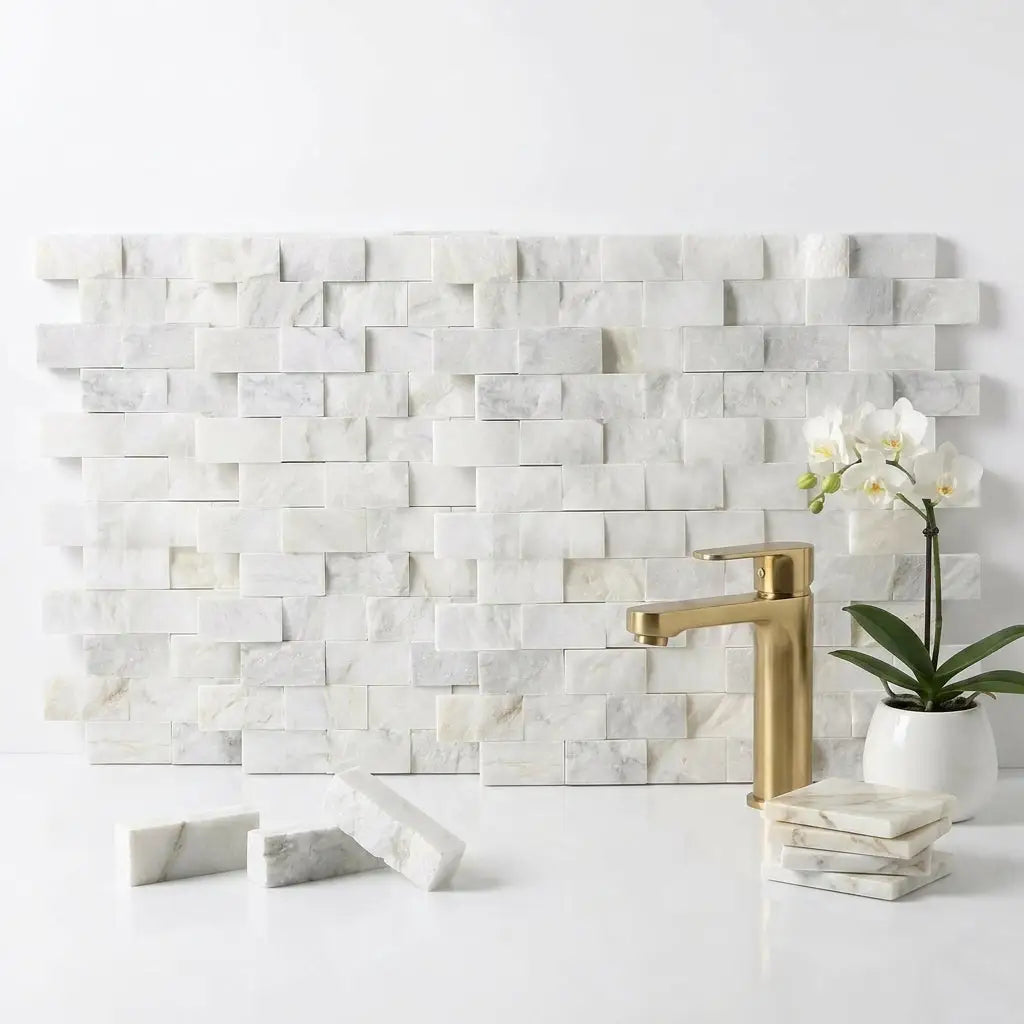 White marble tile backsplash with subtle gray veining in an offset brick layout calacatta gold 1x2 mosaic tile