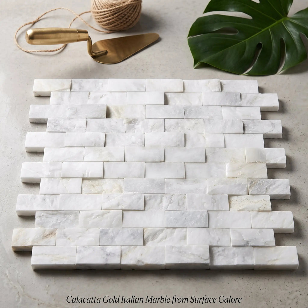 White calacatta gold 1x2 brick split-faced mosaic marble tile with subtle veining in offset brick layout