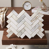 White calacatta gold italian marble tiles arranged in a polished herringbone mosaic pattern for elegant interiors