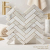White calacatta gold 1x4 herringbone mosaic marble tile polished with gold-toned grout in italian marble