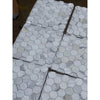 White 2 inch hexagon marble mosaic tile with subtle gray veining wrapped in clear plastic for polished or honed use
