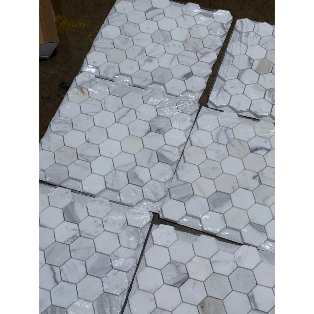 White 2 inch hexagon marble mosaic tile with subtle gray veining wrapped in clear plastic for polished or honed use