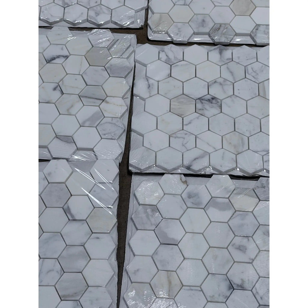 Calacatta gold 2 inch hexagon mosaic marble tile polished with white hexagonal shape and subtle gray veining in clear packaging
