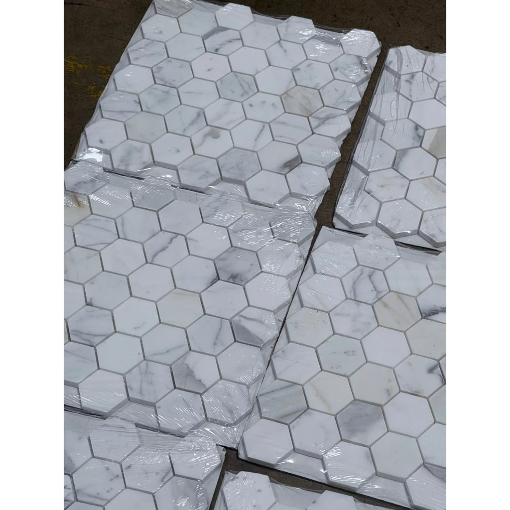 Calacatta gold 2 inch hexagon mosaic marble tile polished with white marble and subtle gray veining wrapped in plastic