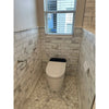 White toilet with black lid in bathroom featuring calacatta gold 2 inch hexagon mosaic marble tile polished or honed
