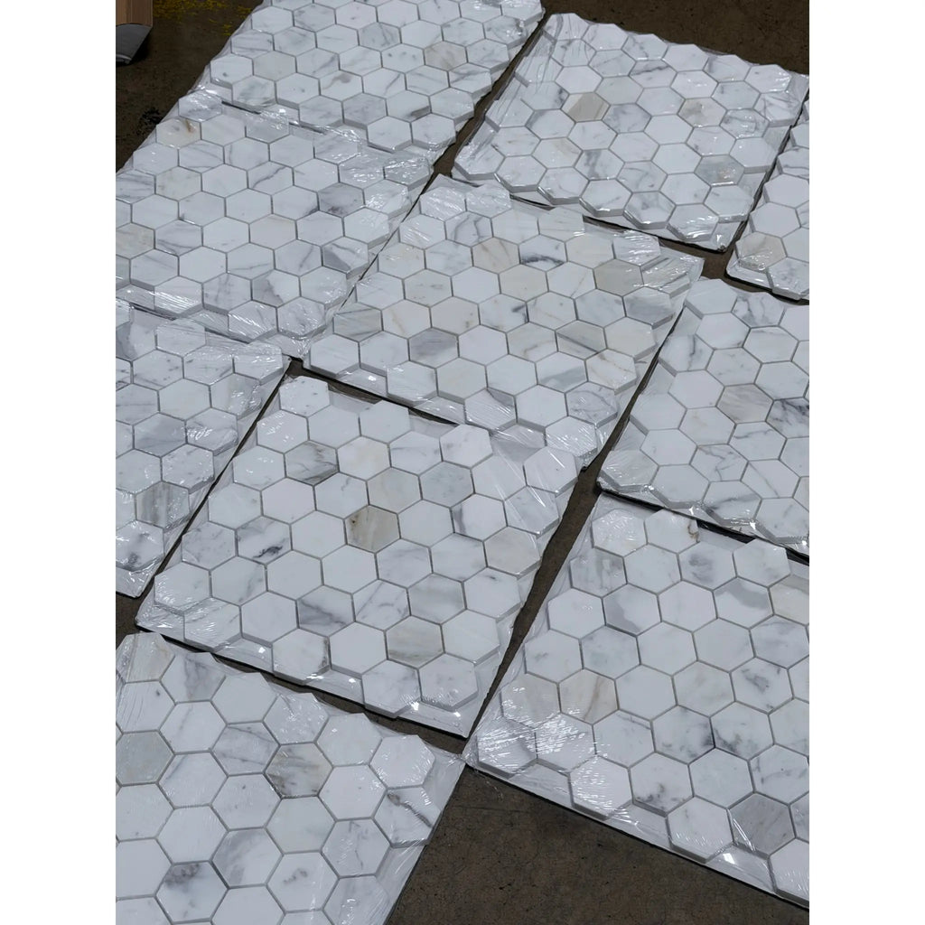 Calacatta gold 2 inch hexagon mosaic marble tile polished or honed with white hexagonal marble and subtle gray veining packaged in clear plastic