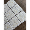 White hexagonal calacatta gold marble mosaic tile with subtle veining and polished glossy finish