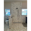 White marble subway tile shower wall with chrome showerhead featuring calacatta gold 2 inch hexagon mosaic tile polished