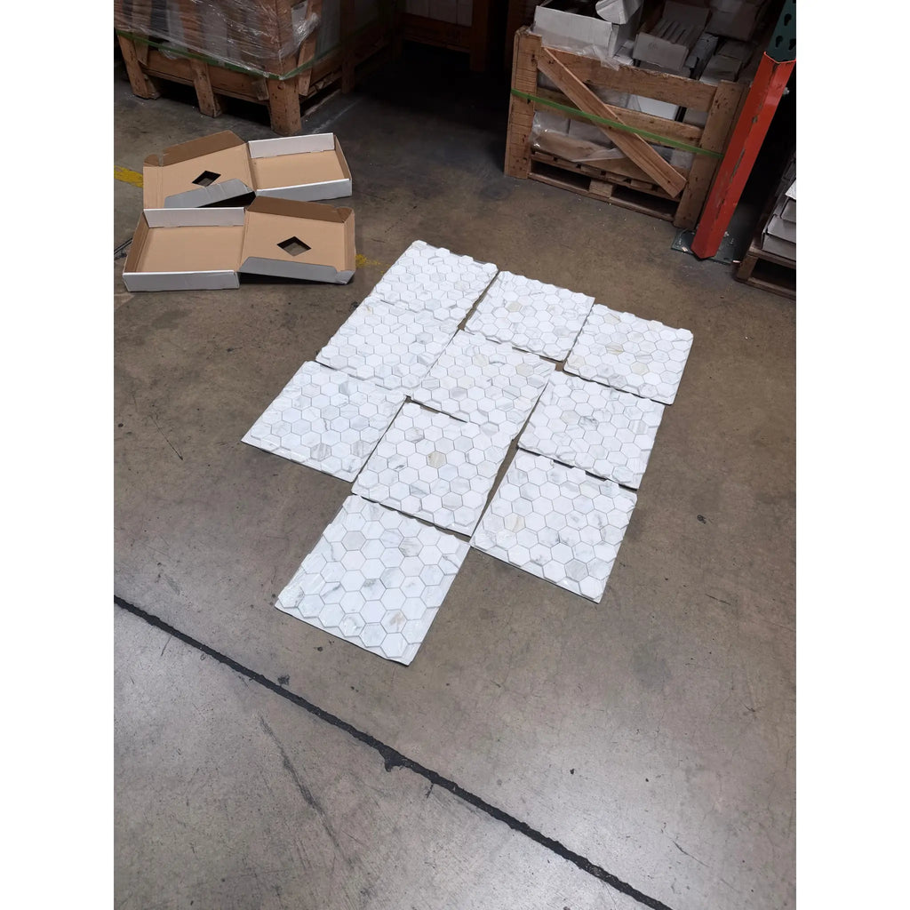 Calacatta Gold 2 inch hexagon mosaic marble tile polished white with subtle gray veining arranged on floor