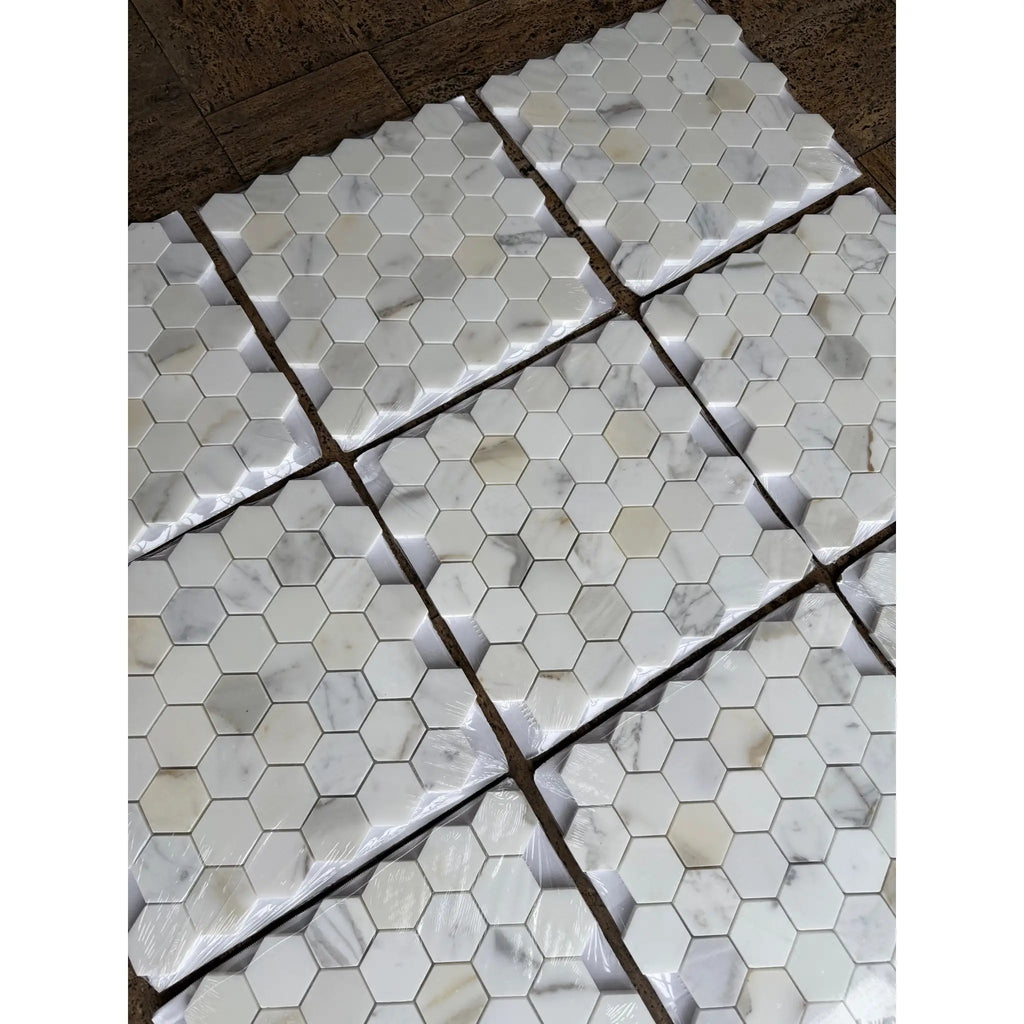 White hexagonal calacatta gold marble mosaic tile with subtle gray veining polished or honed finish