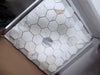 Calacatta Gold 2-inch white hex marble mosaic tile with gray veining in plastic