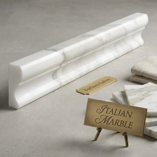 A sleek white italian marble calacatta gold 2x12 crown molding with gray veining and polished finish