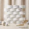 Calacatta gold 2x4 round-faced polished italian marble tiles arranged in classic brick pattern with white and gray veining