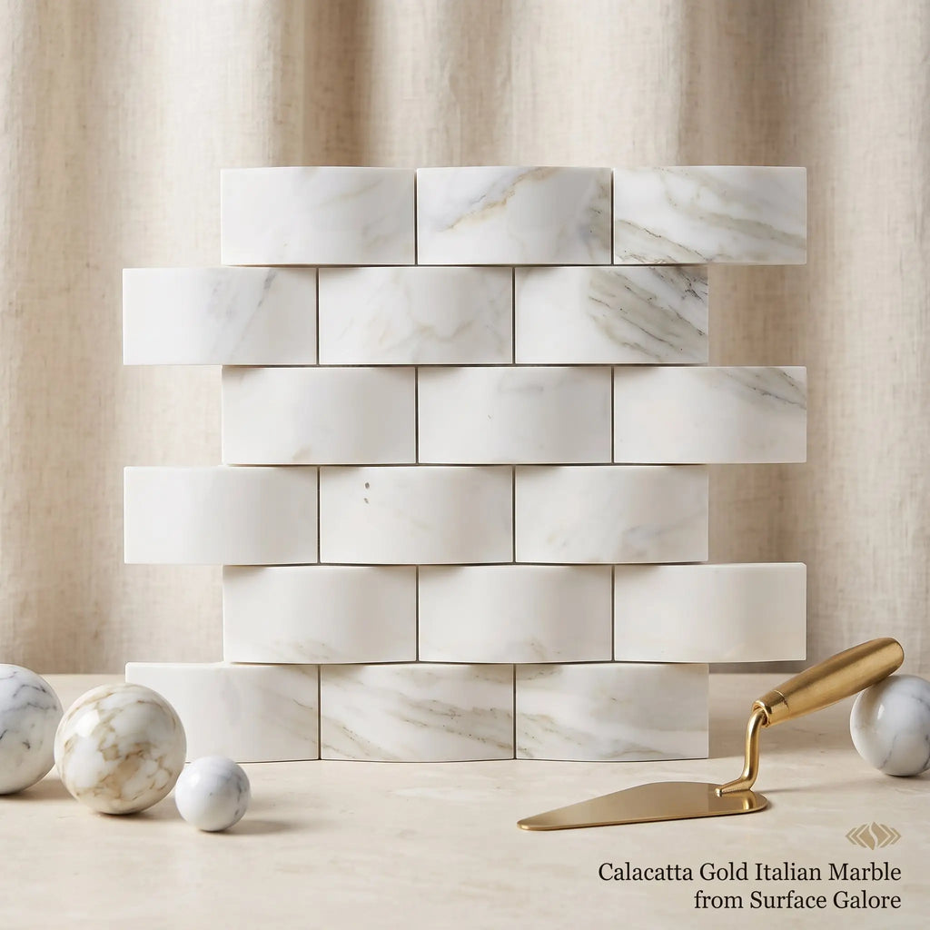 Calacatta gold 2x4 round-faced polished italian marble tiles arranged in classic brick pattern with white and gray veining