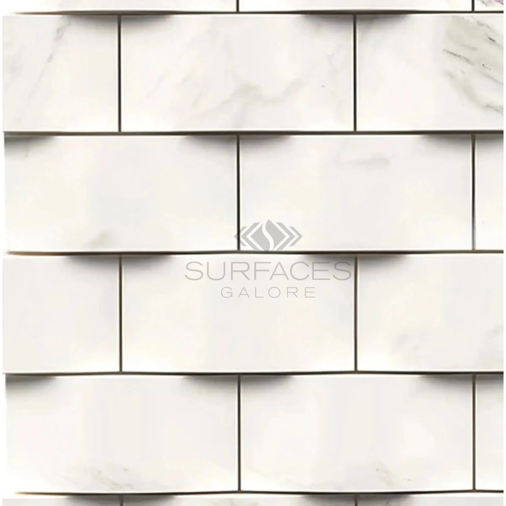 Calacatta Gold 2X4 Round-Faced Mosaic Marble Tile on a White Marble Brick Wall