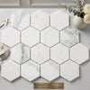 White hexagonal calacatta gold italian marble tiles with subtle gray veining polished or honed finish