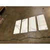 Four white marble calacatta gold baseboard trim moldings with gray veining wrapped in clear plastic for polished or honed finish