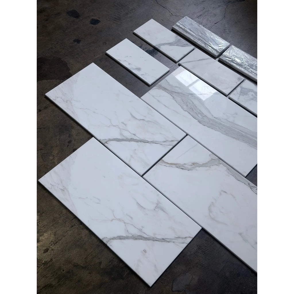 Calacatta Gold white marble-effect 4 3/4x12 baseboard trim with gray veining and silver foil accents