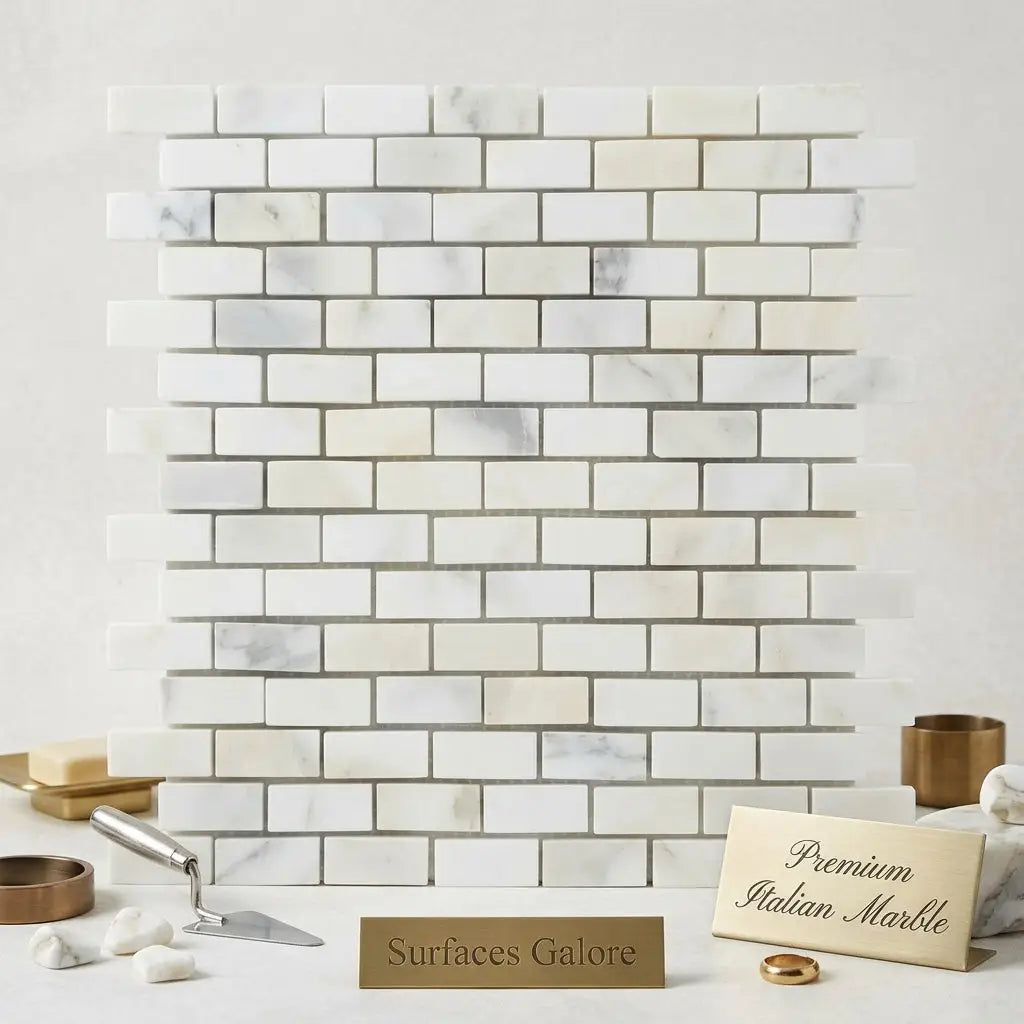 White italian marble calacatta gold mini-brick mosaic tile with subtle gray veining in a polished or honed finish